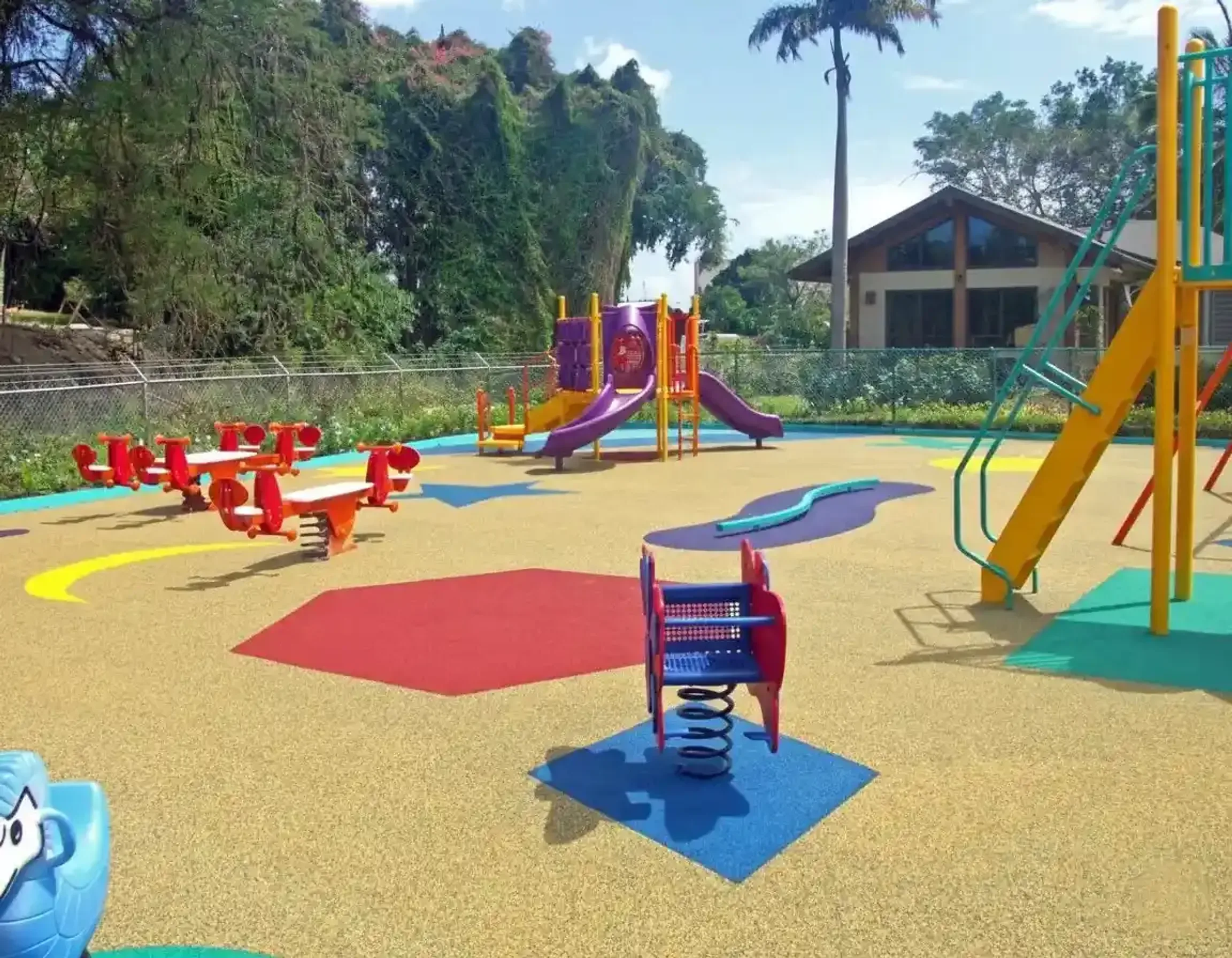 Multicolored poured rubber playground under play equipment