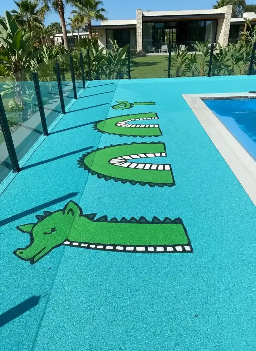 Turquoise poured rubber pool surround with custom alligator graphics