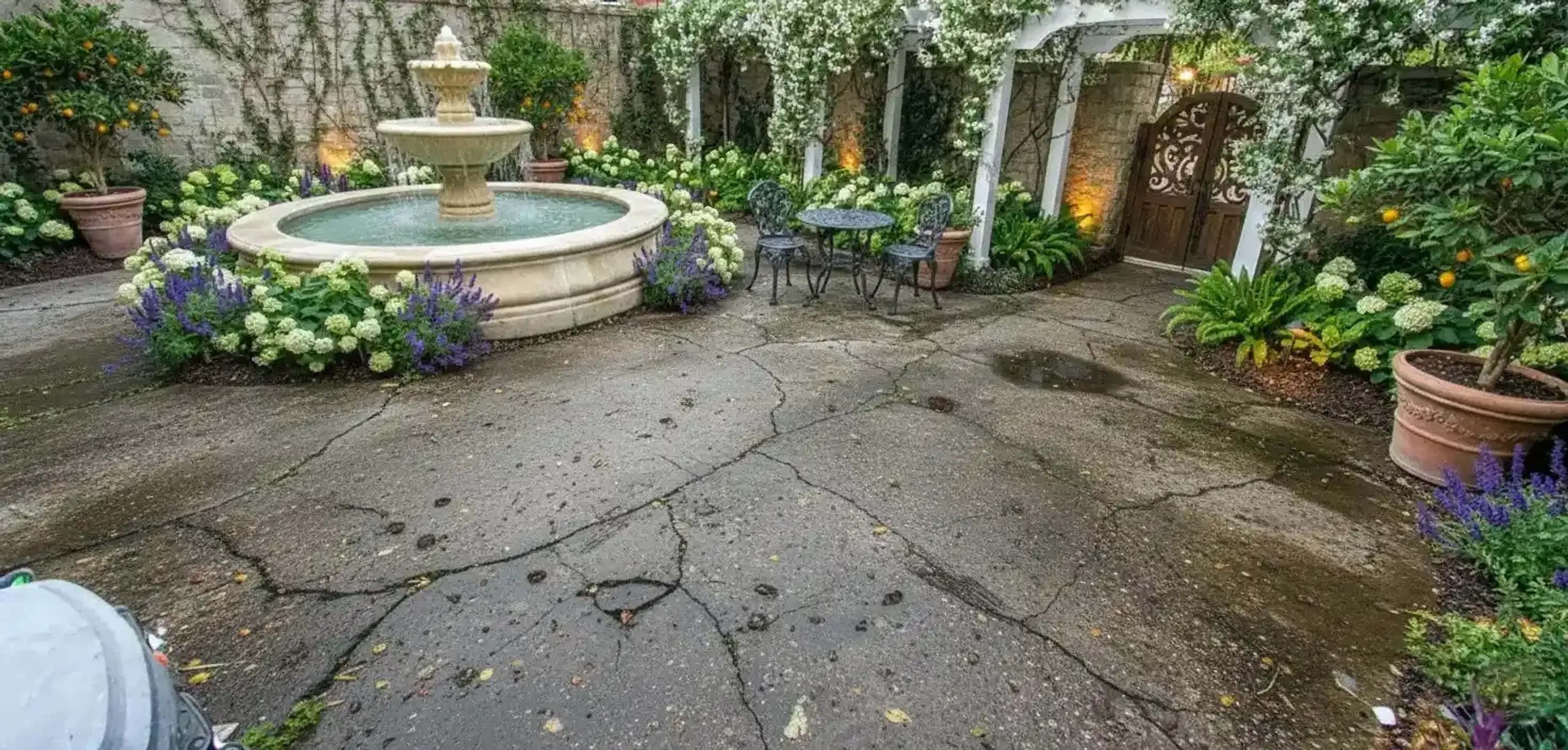 Courtyard around a stone fountain resurfaced in grey speckled rubber
